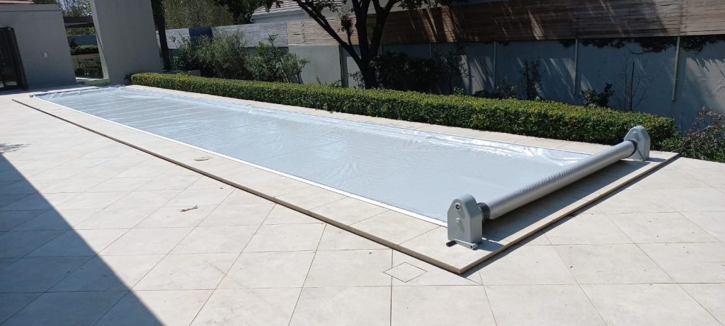 designer pool covers A pool with a cover on it.